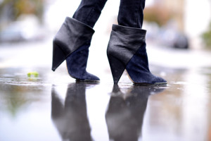 iron suede navy blue and black booties standing in a puddle and seeing the ripples