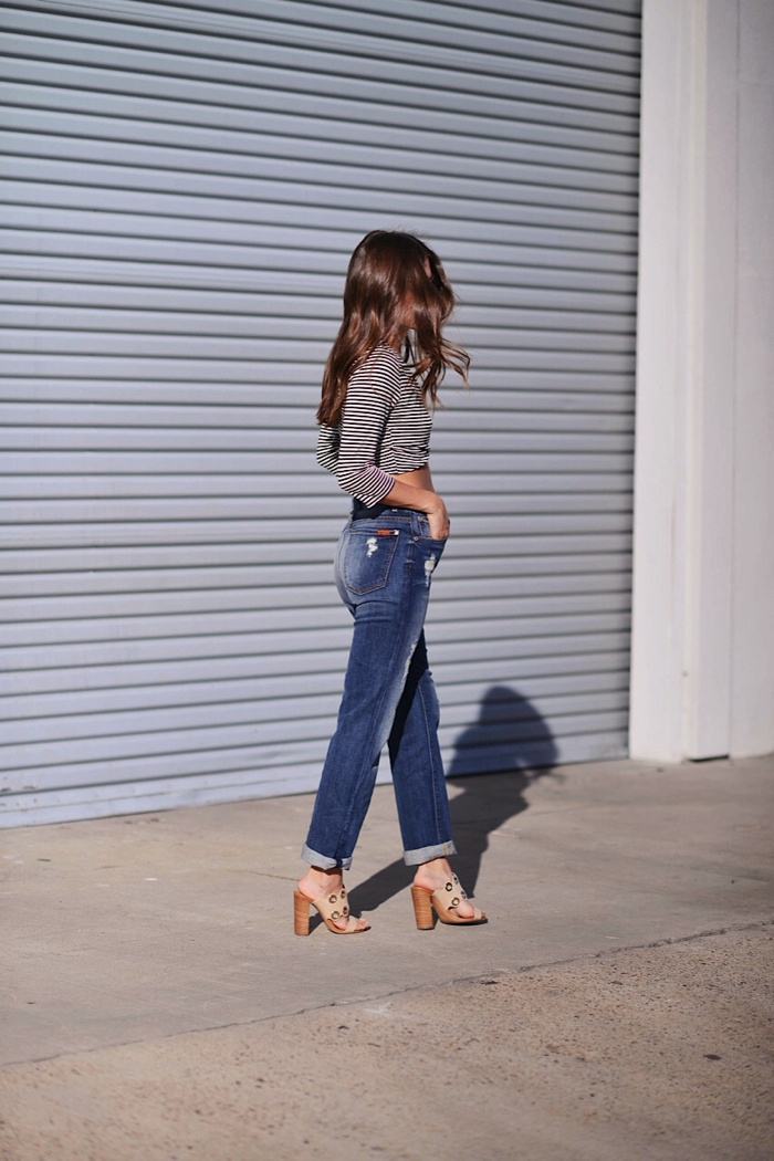 Denim jeans with mules and striped shirt with women looking away
