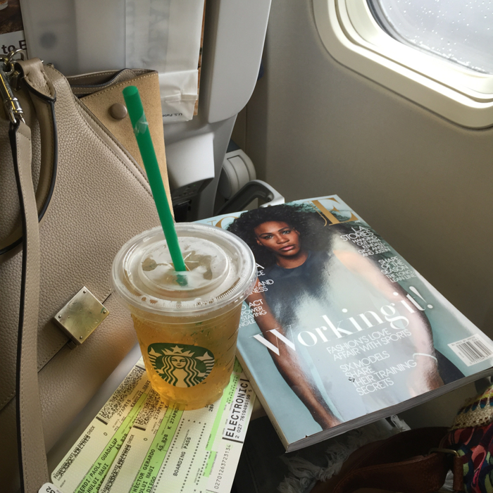 blank itinerary travel essentials on the plane are starbucks and vogue