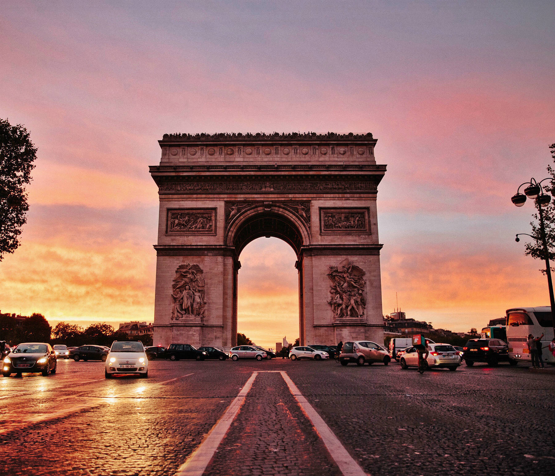 Pink and orange sunset at the Arc de Triomphe in Paris.
