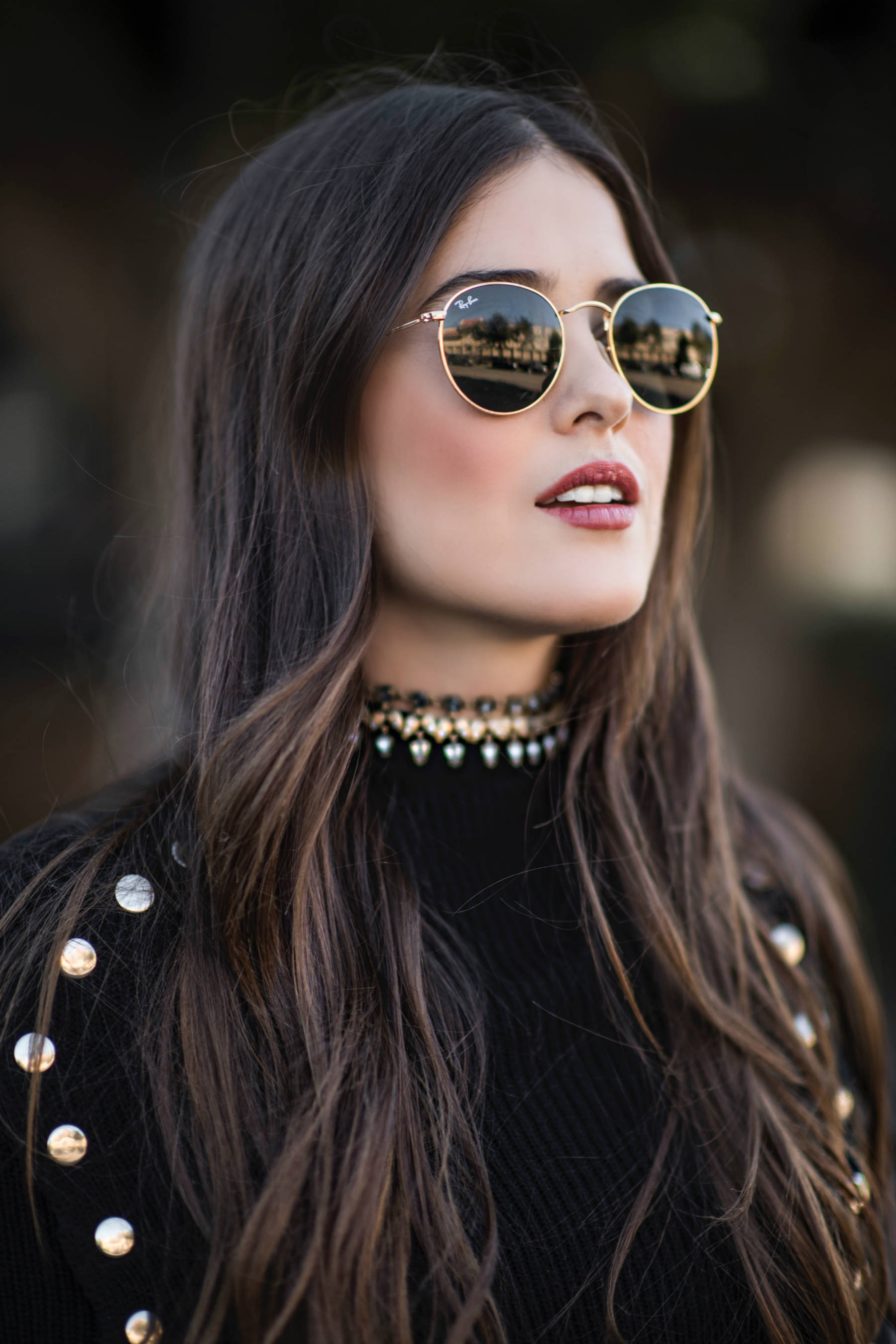Blank Itinerary in a black sweater and Bauble Bar choker.