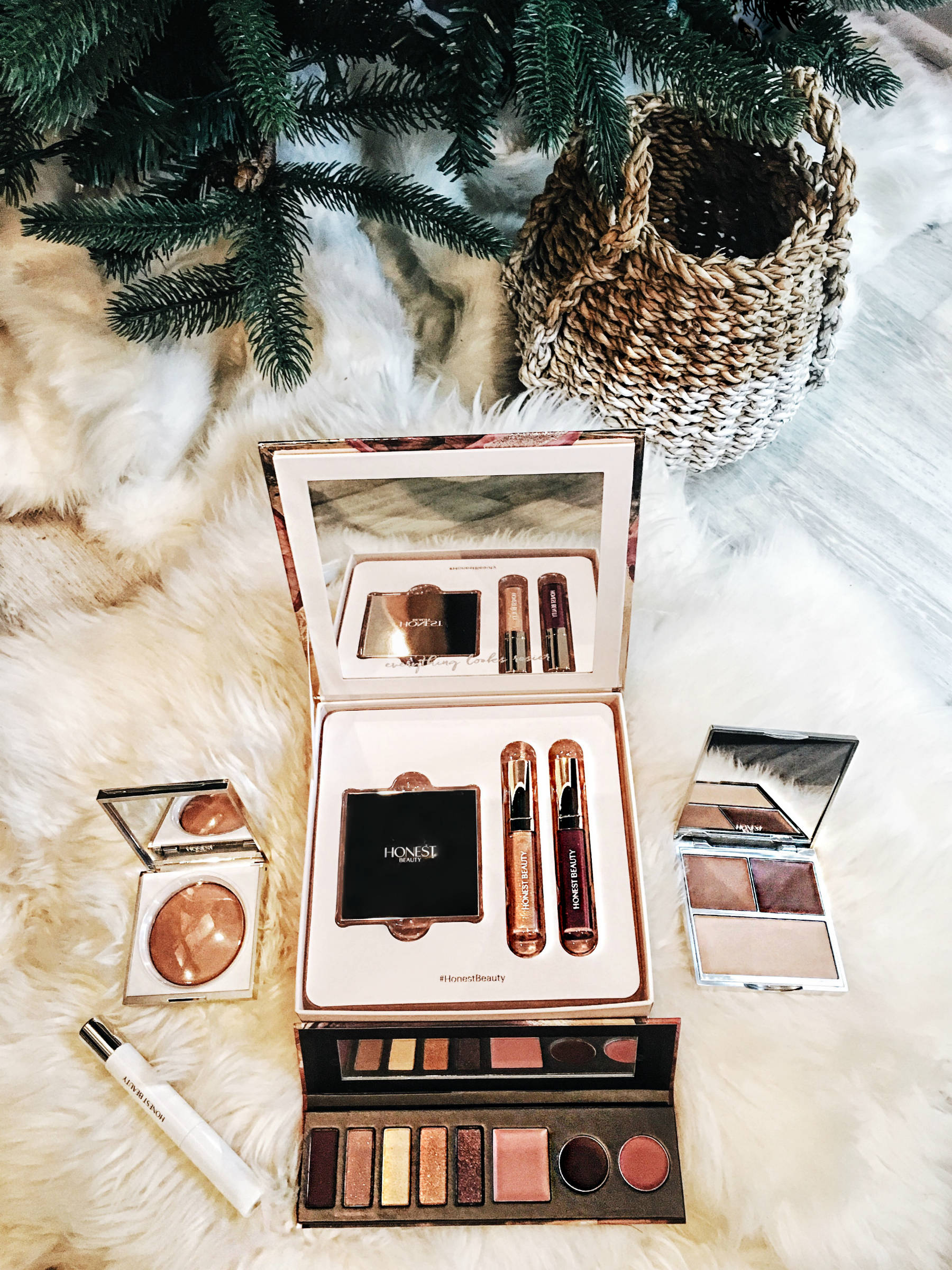 Holiday Giveaway item Honest Beauty make-up set under christmas tree.