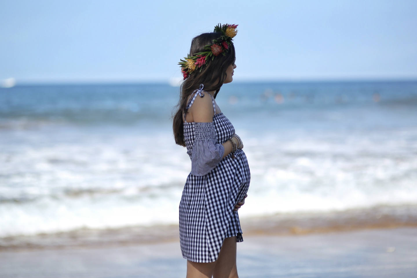girl wearing a flower crown at the beach