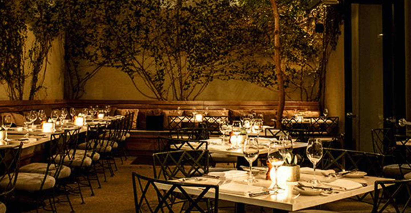 Night candlelit dinner tables at Lucques restaurant in Los Angeles